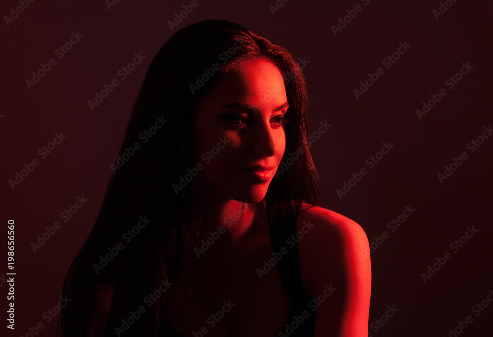 Creative portrait of a beautiful female model close-up. Red lighting in the  Studio. Stock Photo | Adobe Stock