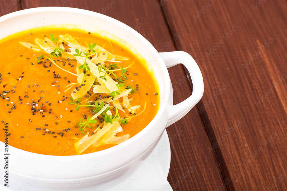 Pumpkin carrot cream soup with parmesan and green shoots of watercress Pumpkin carrot cream soup with parmesan and green shoots of watercress