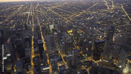 Chicago aerial view flying over Madison Street looking down on to Trump Tower and the Chicago River, moving towards Willis Tower at dusk
