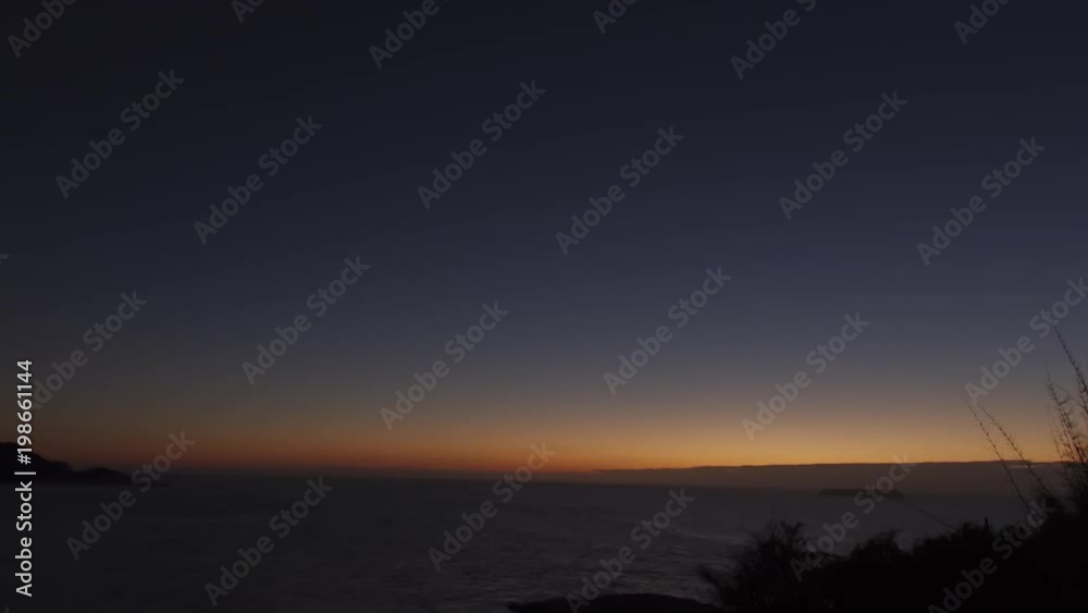 Time lapse - Sunrise at 'Praia Mole' beach. Lights coming from the horizon. Beautiful seascape. Night to day transition. Florianópolis, Santa Catarina / Brazil Time lapse - Sunrise at 'Praia Mole' beach. Lights coming from the horizon. Beautiful seascape. Night to day transition. Florianópolis, Santa Catarina / Brazil