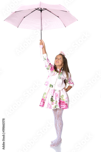 Little girl under an umbrella.