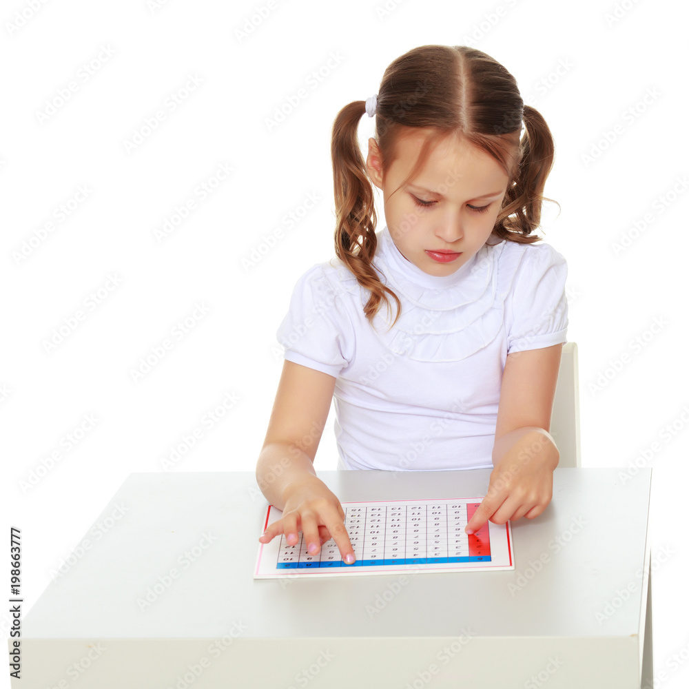 A little girl is studying Montessori stuff. A little girl is studying Montessori stuff.