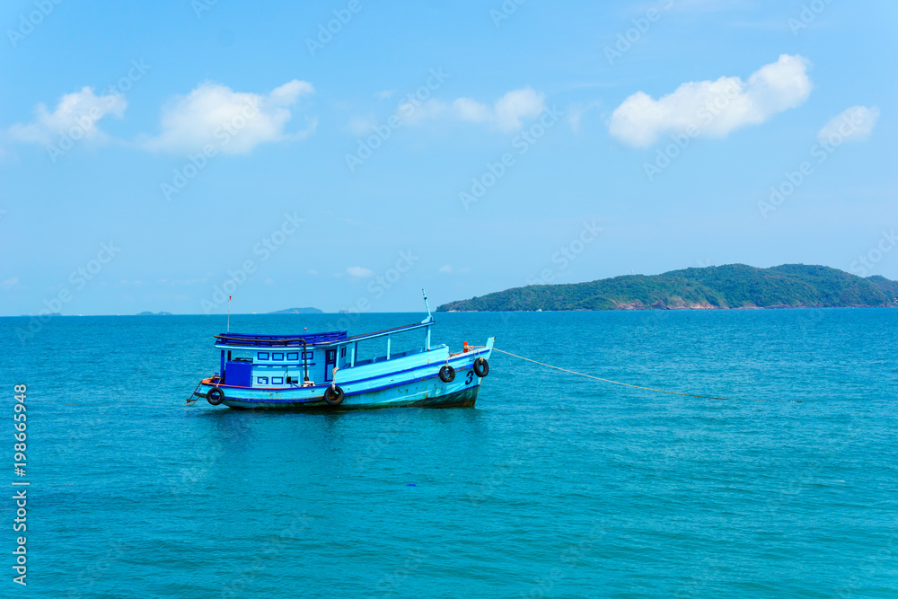 landscape view of seascape and skyline in the ocean with fishing boat and island.