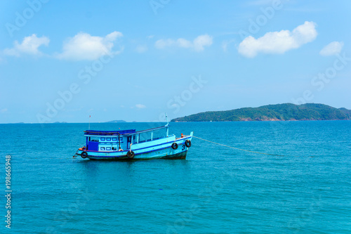 landscape view of seascape and skyline in the ocean with fishing boat and island. © yanadhorn