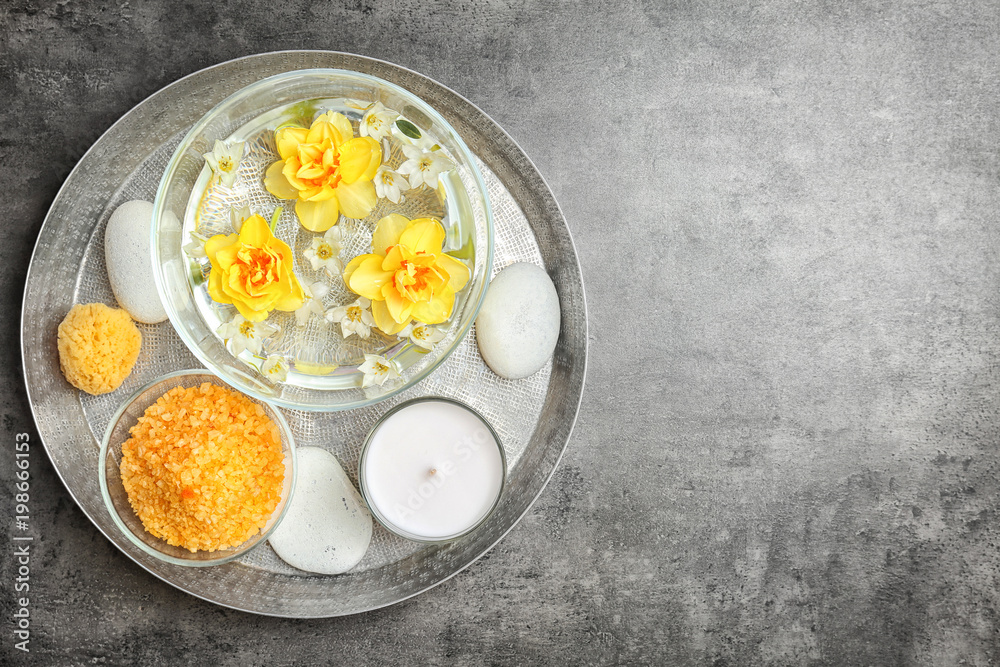 Composition with spa accessories and flowers on grey background Composition with spa accessories and flowers on grey background