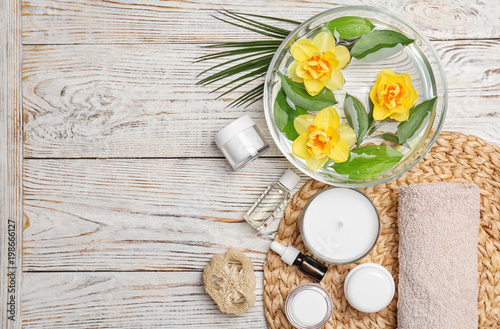 Composition with spa accessories and flowers on wooden background