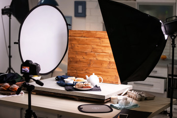 Professional camera on tripod and food composition in photo studio