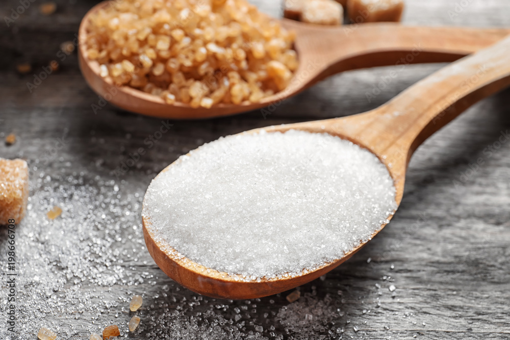 Spoon with white sugar on wooden table Spoon with white sugar on wooden table