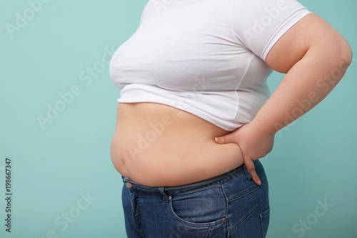 Overweight woman on color background