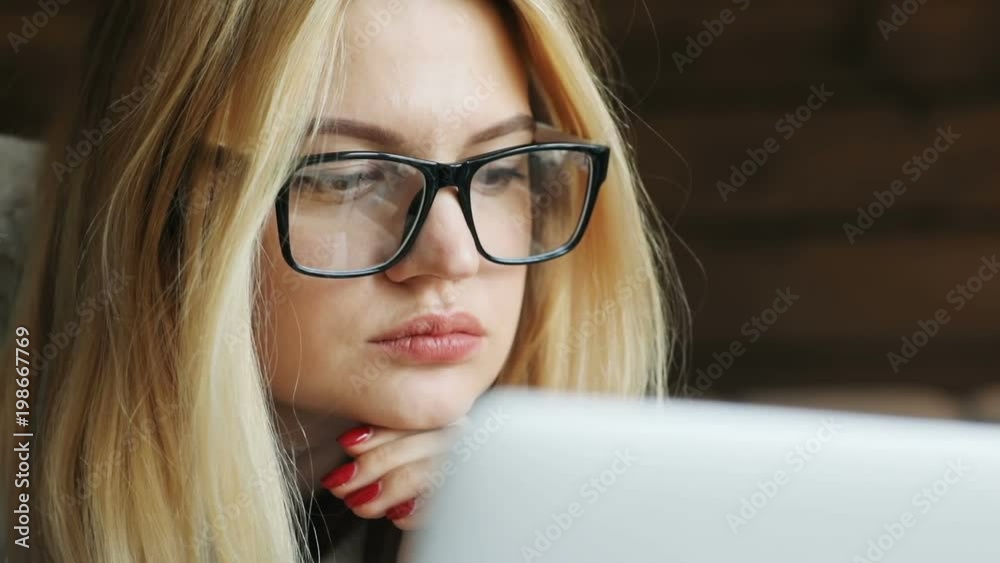 closeup portrait of female person using portable computer laptop looking monitor sad worried emotional face checking news hipster glasses blond woman internet business project manager browser connect closeup portrait of female person using portable computer laptop looking monitor sad worried emotional face checking news hipster glasses blond woman internet business project manager browser connect