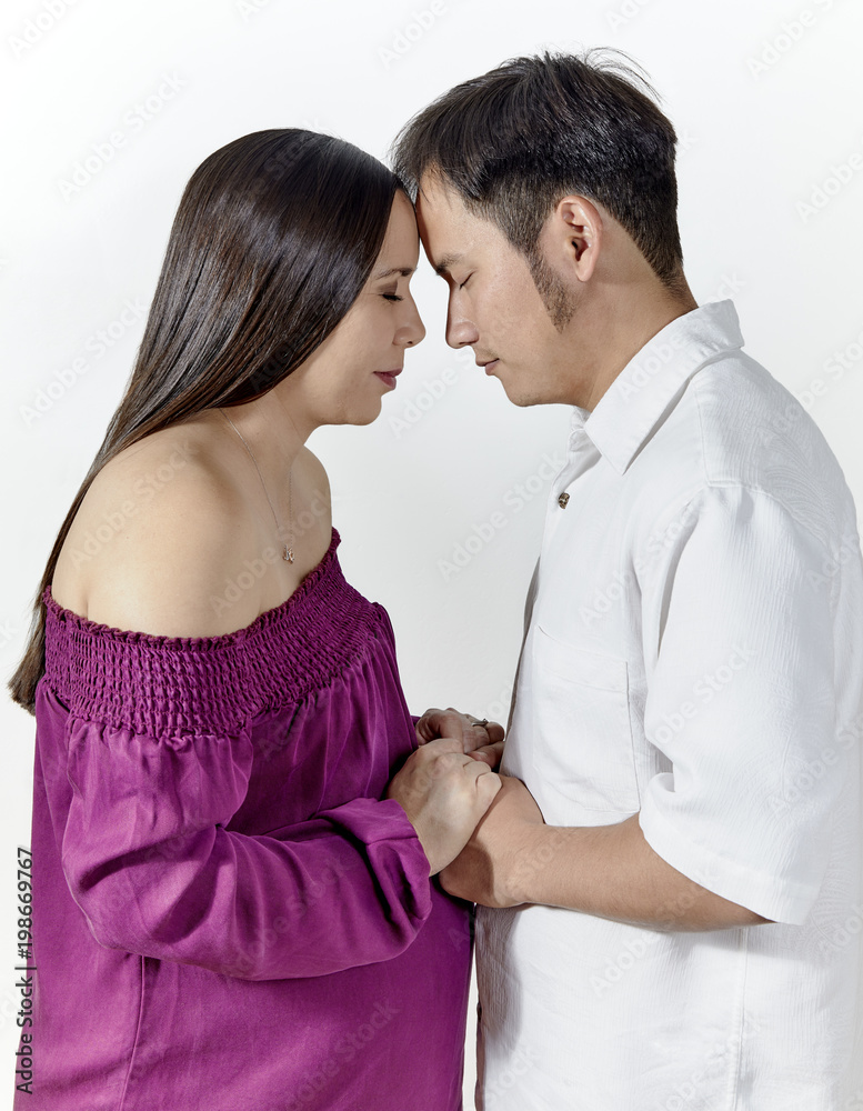 Expecting Young Couple with Foreheads touching and Eyes Closed