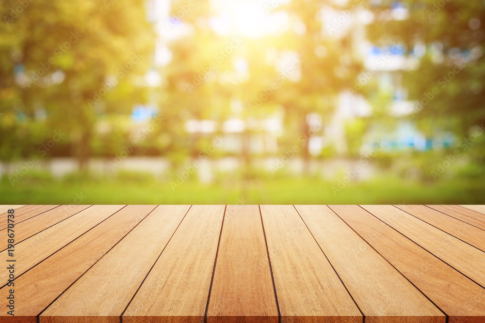 Wooden board or table and abstract blurred background. Free space can be used for photo montage or product display design and advertising Wooden board or table and abstract blurred background. Free space can be used for photo montage or product display design and advertising