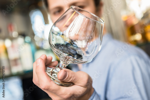 Barman Checking the Clarity of a Glass
