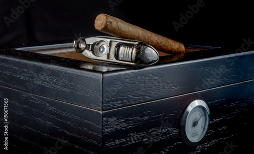 Cigars on a humidor against a black background