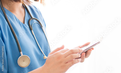 Woman Doctor using mobile phone for searching information , Medical and technology concept.