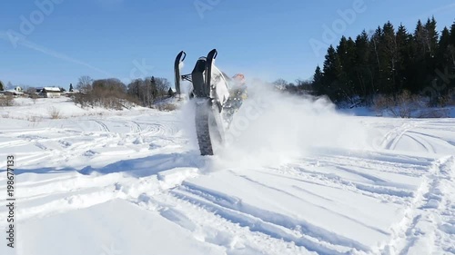 Man on snowmobile in winter mountain