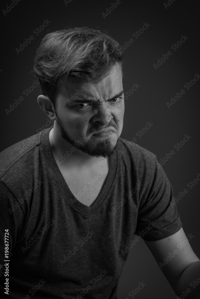 Angry, frustrated and unhappy young Caucasian man