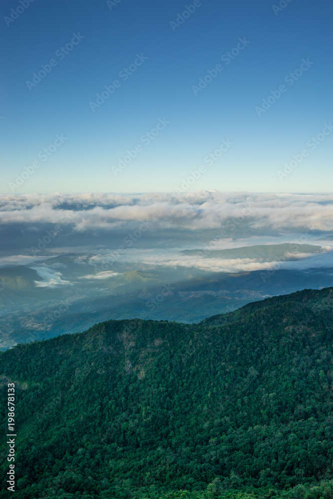 view of landscape on hill and blue sky with cloud and fog
