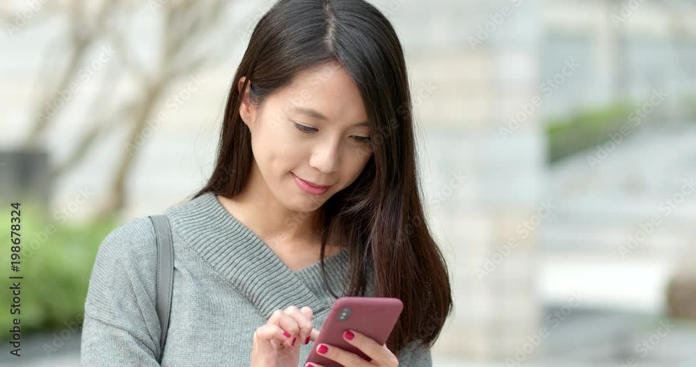 Woman reading on smart phone at outdoor Woman reading on smart phone at outdoor