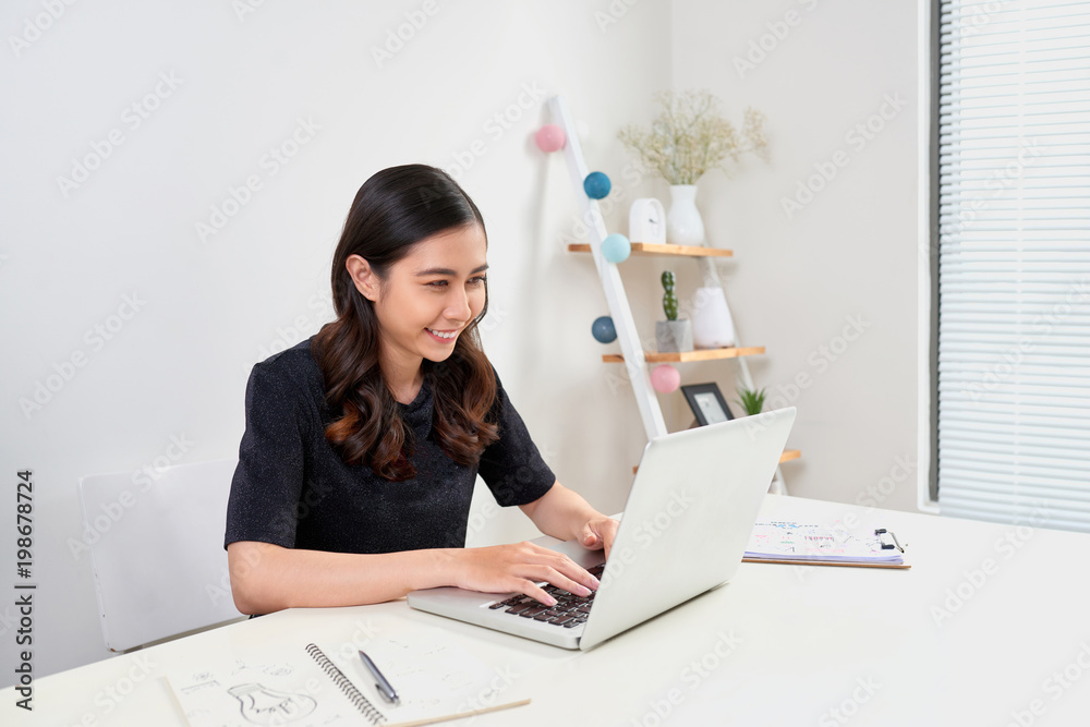 Pretty stylish woman working from home on laptop Pretty stylish woman working from home on laptop