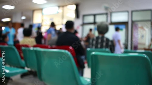 blurred background of Asian patients waiting area in hospital or clinic.