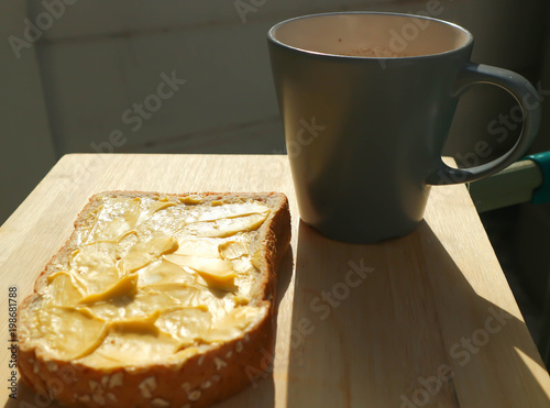 bread with magarine topping and hot drink photo