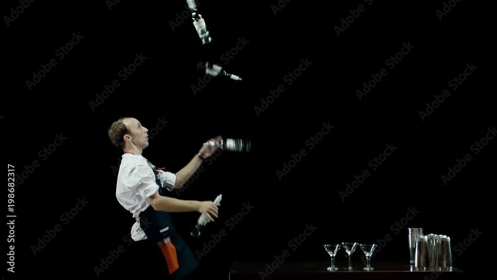 Bartender juggling the objects (4 bottles) 