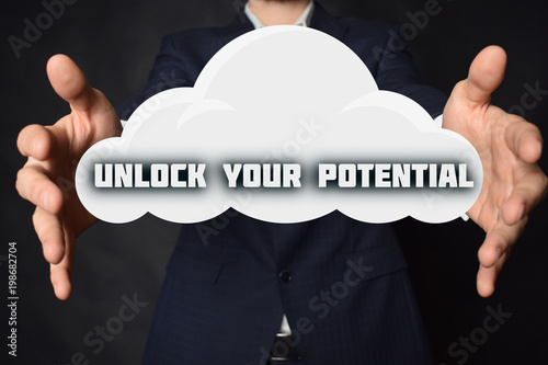 In the hands of a businessman, a cloud with the inscription:UNLOCK YOUR POTENTIAL
