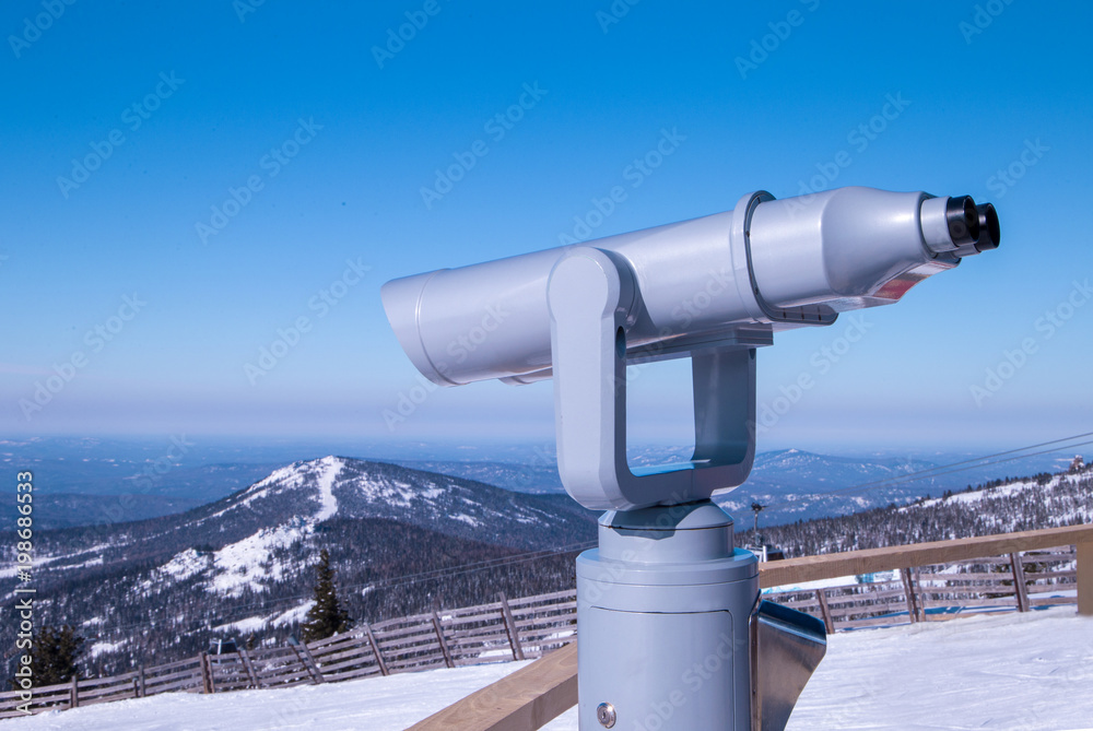 close up old metal binoculars on background viewpoint overlooking the mountain