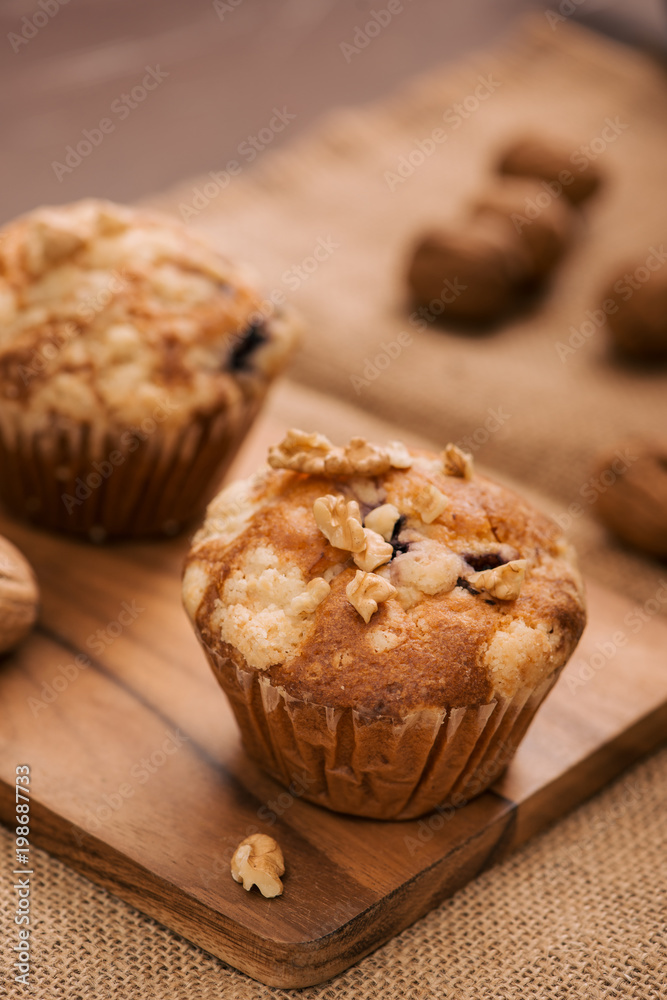 Tasty homemade walnut muffins on table. Sweet pastries Tasty homemade walnut muffins on table. Sweet pastries