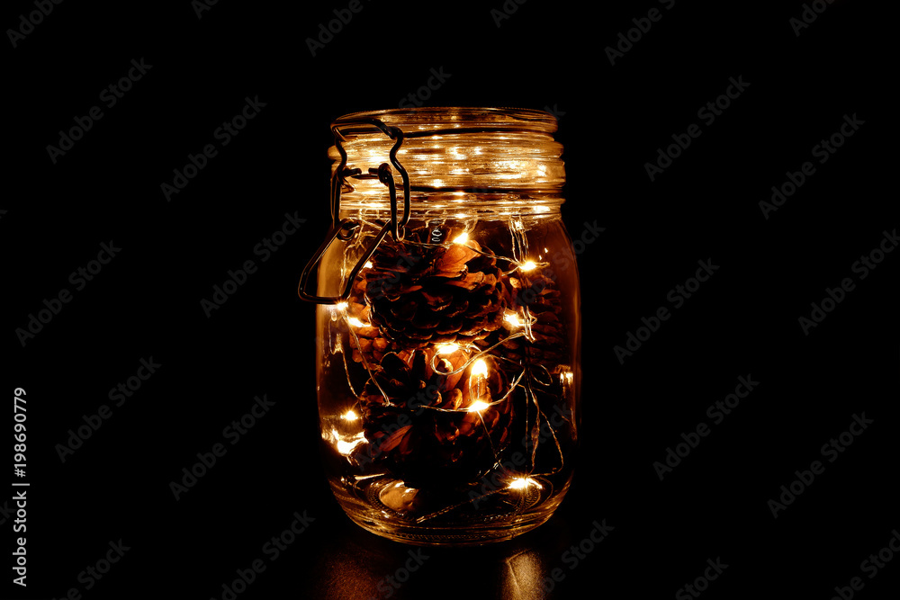 Pine Cones with Fairy Light in a Glass Jar, in the Dark, Low-Key Photography Pine Cones with Fairy Light in a Glass Jar, in the Dark, Low-Key Photography