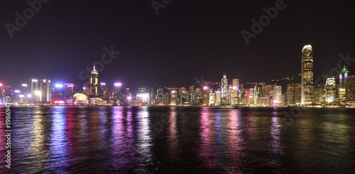 Business District of Hong Kong Island buildings reflecting their lights off the Victoria Harbour © Clint