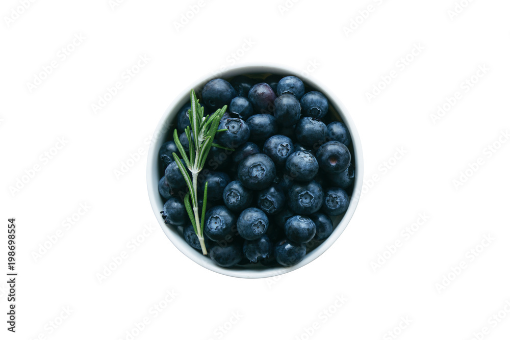 Fresh wild blueberries in white bowl on white isolated background with clipping paths in top view flat lay copy space. Blueberry is antioxidant food and healthy fruits with high vitamin C. Fresh wild blueberries in white bowl on white isolated background with clipping paths in top view flat lay copy space. Blueberry is antioxidant food and healthy fruits with high vitamin C.
