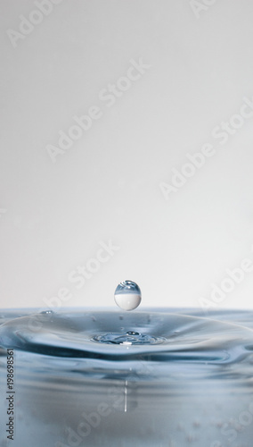 water drop falling on waret surface. close-up