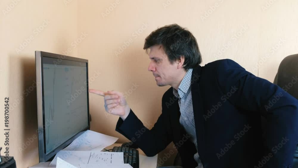 Young man is working hard behind the computer. Young man is working hard behind the computer.