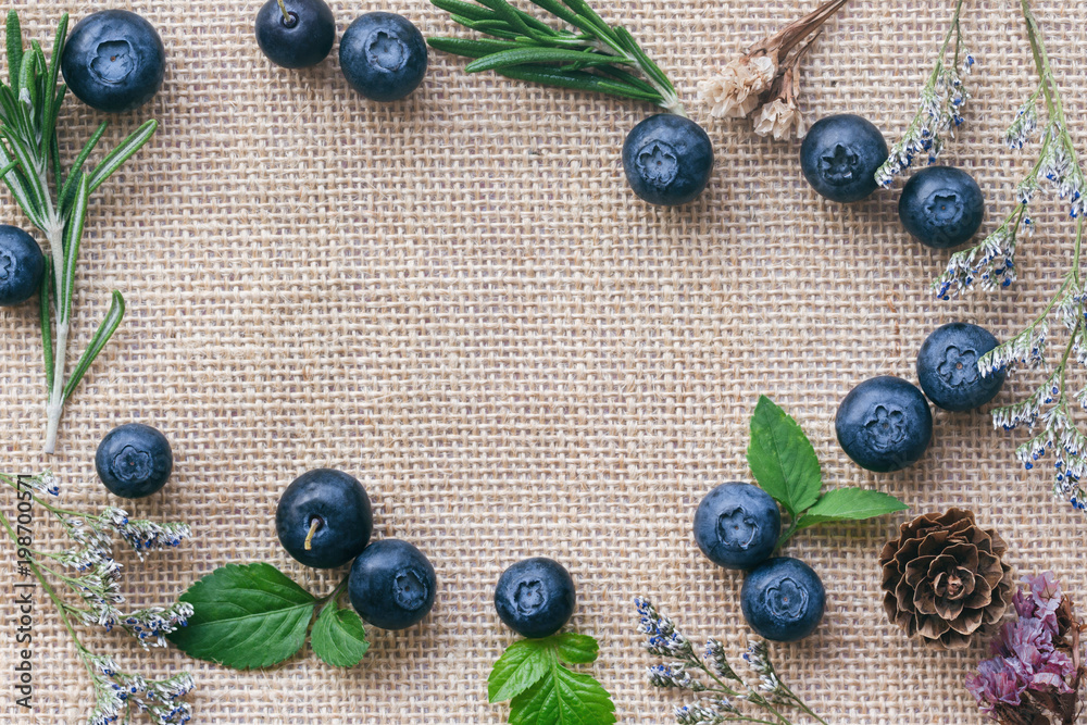 Beautiful background or wallpaper of fresh wild blueberries lay on sack in  top view flat lay