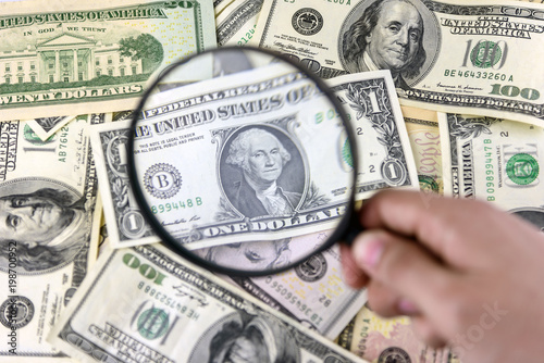 Dollar with magnifier. Magnifying glass and money. Business concept background.