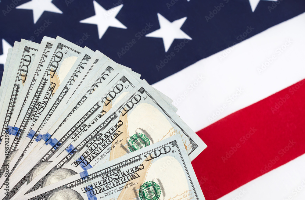 American dollars over background of american flag. American dollars over background of american flag.