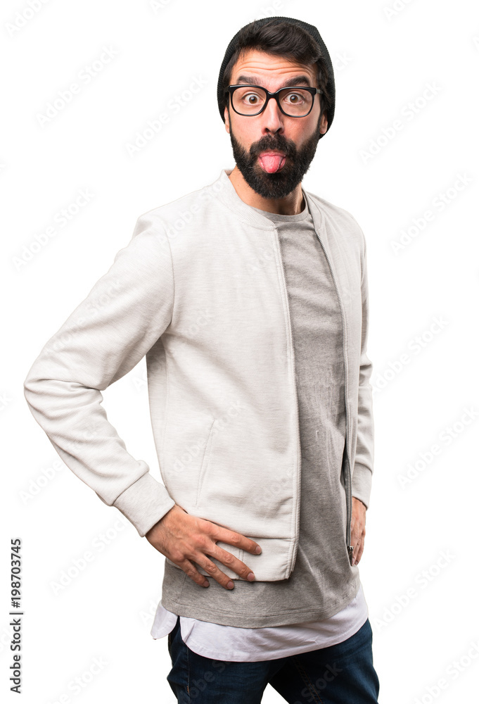 Hipster man taking out his tongue on white background Hipster man taking out his tongue on white background