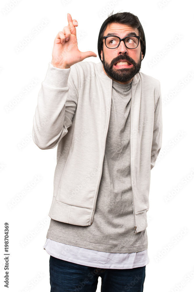 Hipster man with his fingers crossing on white background