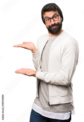 Hipster man presenting something on white background