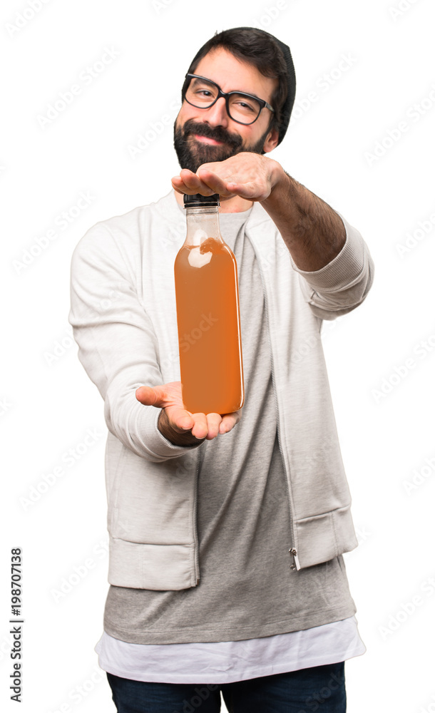 Happy Hipster man holding an orange juice on white background Happy Hipster man holding an orange juice on white background
