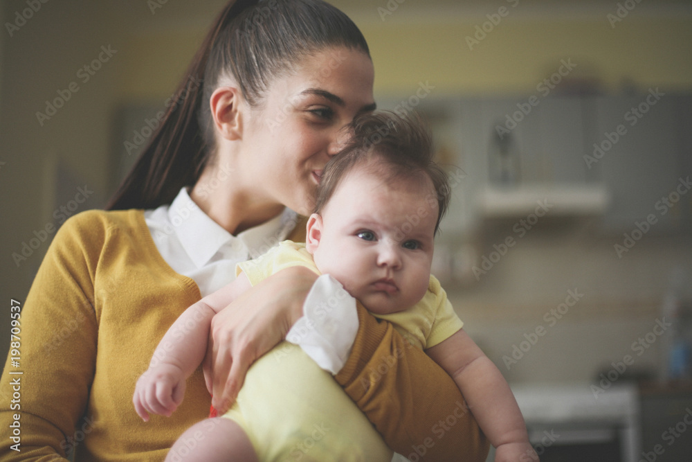 Mother with baby at home.