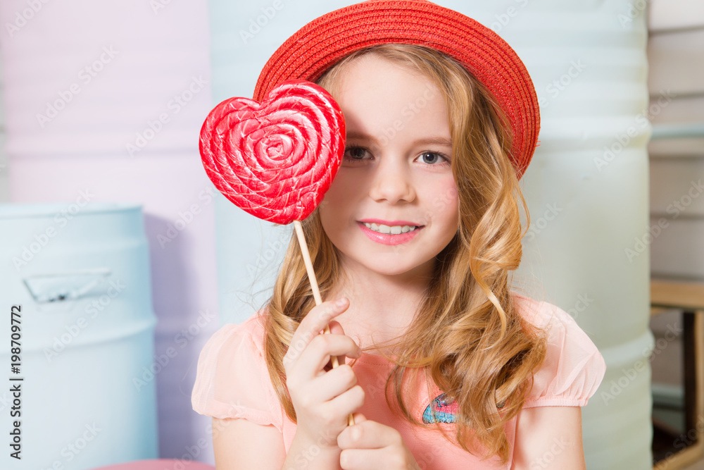 Little girl eating  candy  colourful lollipop.