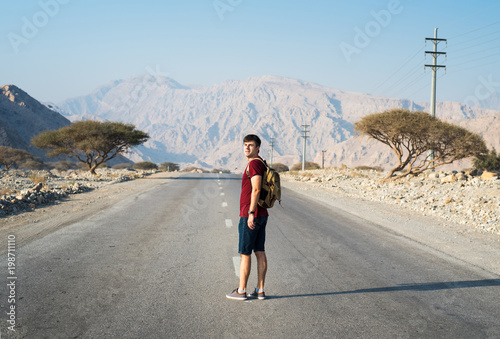 Man walking on the empty dessert road © creativefamily