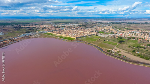 Aerial view on the pink salt lake and Aigues-Mortes - medieval fortified town in South France © chocolatefather