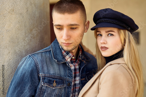 Lovely couple stand on city landscape and hug each other with sun on background