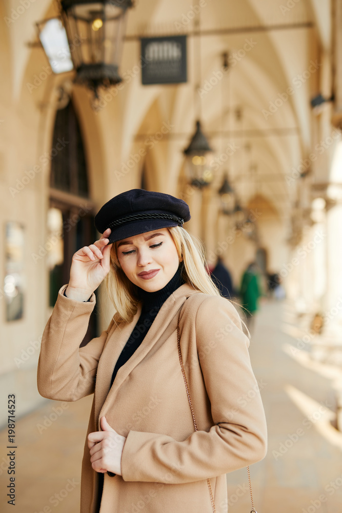 Fototapeta premium Young pretty girl walking on the street and smile