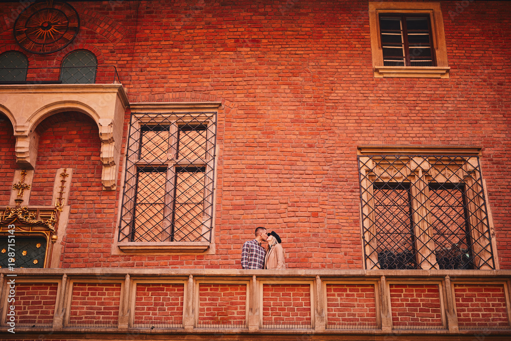 Lovely couple kiss each other on the building with beautiful view Lovely couple kiss each other on the building with beautiful view