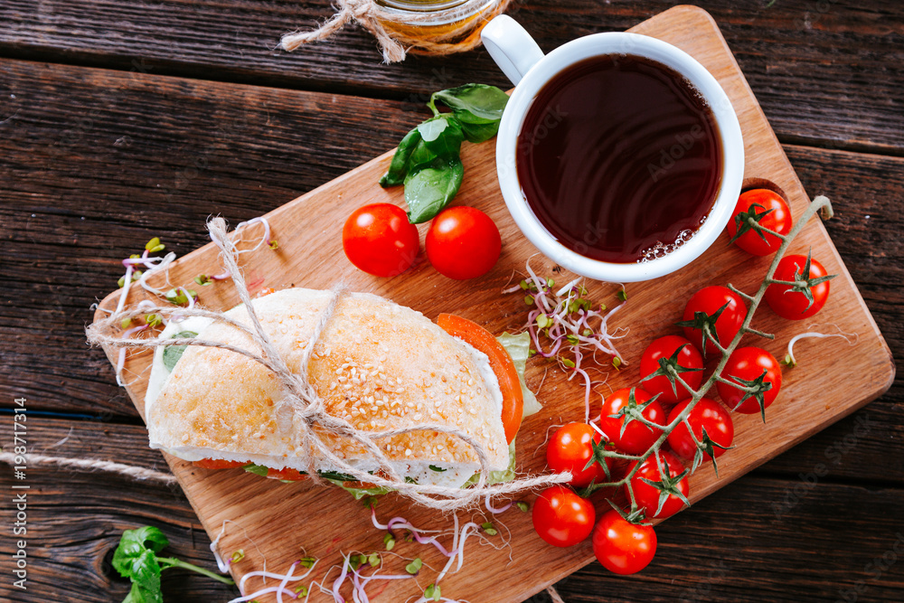 Sandwich with tomato, cheese and  lettuce